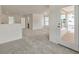 Spacious living room featuring carpet floors, white walls, and a door to a porch at 120 Shingle Oak Dr, Moncks Corner, SC 29461