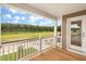 Inviting porch with wood flooring and serene views of the open backyard and lush forest at 120 Shingle Oak Dr, Moncks Corner, SC 29461
