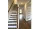 Bright foyer featuring a staircase with wood handrail and hardwood floors at 120 Shingle Oak Dr, Moncks Corner, SC 29461