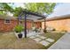 Inviting backyard patio with pergola, seating area, and well-manicured lawn at 1251 Charlestowne Dr, Charleston, SC 29407