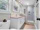 Modern bathroom featuring a glass shower, neutral tiling, and sink with storage at 1251 Charlestowne Dr, Charleston, SC 29407