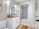 Bathroom with white vanity, mosaic tile accents, and tub with shower at 1251 Charlestowne Dr, Charleston, SC 29407