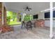 Covered patio with dining table, ceiling fan, and an outdoor brick fireplace at 1251 Charlestowne Dr, Charleston, SC 29407
