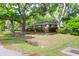 Charming single-story brick home with mature trees and a well-maintained lawn at 1251 Charlestowne Dr, Charleston, SC 29407