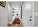 Hallway with hardwood floors, light walls, and modern decor, leading to rooms at 1251 Charlestowne Dr, Charleston, SC 29407