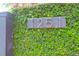 Close-up of house number on brick wall covered in ivy at 1251 Charlestowne Dr, Charleston, SC 29407