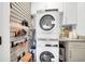 Well-organized laundry room featuring stacked washer and dryer and storage at 1251 Charlestowne Dr, Charleston, SC 29407