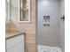 Close up of the stand up shower featuring lovely tile work and built in storage at 1251 Charlestowne Dr, Charleston, SC 29407