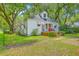 Charming home features a red front door, brick stairs, and shade trees at 1259 Wisteria Rd, Charleston, SC 29407