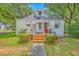 Charming home featuring a red front door, brick stairs, and shade trees at 1259 Wisteria Rd, Charleston, SC 29407