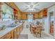 Cozy eat-in kitchen with wood cabinets, a ceiling fan and ample counter space at 1259 Wisteria Rd, Charleston, SC 29407