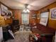 Wood paneled den with a comfortable sofa and lots of wall art at 1259 Wisteria Rd, Charleston, SC 29407