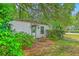 Outbuilding with a white exterior, green trim, and a small window at 1259 Wisteria Rd, Charleston, SC 29407