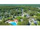 Scenic aerial view of a Gathering-friendly neighborhood with tree-lined streets, a community pool, and verdant surroundings at 1315 Palm Cove Dr, Charleston, SC 29492