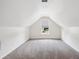 Spacious finished attic with carpet, recessed lighting, and a window providing natural light at 1315 Palm Cove Dr, Charleston, SC 29492