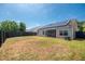 Fenced backyard features a well-maintained lawn, patio, and home's exterior with solar panels at 1315 Palm Cove Dr, Charleston, SC 29492
