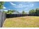 Large backyard features a dark wood fence and a view of neighboring houses at 1315 Palm Cove Dr, Charleston, SC 29492