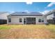 View of the back of the home showing a screened porch and solar panels on the roof at 1315 Palm Cove Dr, Charleston, SC 29492