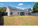 View of the home's backyard with a screened porch and solar panels on the roof at 1315 Palm Cove Dr, Charleston, SC 29492