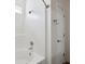 Clean, white bathroom featuring a shower-tub combo, window, and updated fixtures at 1315 Palm Cove Dr, Charleston, SC 29492