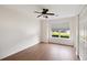 Bright bedroom features hardwood floors, ceiling fan, large window with blinds, and a double door closet at 1315 Palm Cove Dr, Charleston, SC 29492