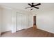 This bright bedroom has hardwood floors, double door closet, ceiling fan, and an attached bathroom at 1315 Palm Cove Dr, Charleston, SC 29492