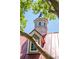 Close up view of the clubhouse cupola and roof details, framed by tree branches at 1315 Palm Cove Dr, Charleston, SC 29492