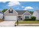 Charming single-story home with well-maintained lawn and attached two car garage at 1315 Palm Cove Dr, Charleston, SC 29492