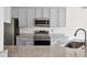 Kitchen with stainless steel appliances, granite countertops and grey cabinets at 1315 Palm Cove Dr, Charleston, SC 29492