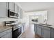 Modern kitchen featuring stainless steel appliances, granite countertops, and wood-look floors at 1315 Palm Cove Dr, Charleston, SC 29492