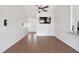 Open-concept living room featuring vaulted ceilings, modern ceiling fan and sleek, wood-look floors at 1315 Palm Cove Dr, Charleston, SC 29492