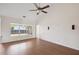 Living room with a ceiling fan, wood-look floors, and a window at 1315 Palm Cove Dr, Charleston, SC 29492
