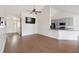 Inviting living room with hardwood floors, ceiling fan, and open layout to the kitchen at 1315 Palm Cove Dr, Charleston, SC 29492