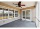 Cozy screened-in porch perfect for enjoying the outdoors with a ceiling fan and backyard view at 1315 Palm Cove Dr, Charleston, SC 29492