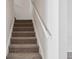 Staircase featuring carpeted steps and a white handrail, connecting different levels of the home at 1315 Palm Cove Dr, Charleston, SC 29492