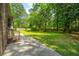 Spacious backyard boasts a well-maintained lawn, framed by lush greenery and trees at 136 Harrow Pl, Goose Creek, SC 29445