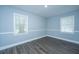 Simple bedroom showing pale blue walls, gray flooring and twin windows at 136 Harrow Pl, Goose Creek, SC 29445