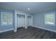 Bright bedroom features a hardwood floor, large windows, light blue walls and two closets at 136 Harrow Pl, Goose Creek, SC 29445