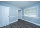 Comfortable bedroom with wood-look flooring, light-blue walls, a closet, and natural light, creating a serene space at 136 Harrow Pl, Goose Creek, SC 29445