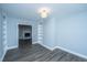 Bonus room featuring stylish built-in shelving units and hardwood floors, leading to a fireplace at 136 Harrow Pl, Goose Creek, SC 29445