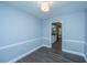 Dining room showing pale blue walls and gray flooring leading to a modern kitchen at 136 Harrow Pl, Goose Creek, SC 29445