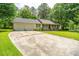 Inviting one-story house featuring an attached garage and a sprawling concrete driveway at 136 Harrow Pl, Goose Creek, SC 29445