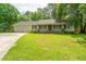 Charming single-story home with a well-manicured front lawn and attached two-car garage at 136 Harrow Pl, Goose Creek, SC 29445
