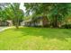 Grassy front yard with lovely trees, leading to a home with a gray roof and a two-car garage at 136 Harrow Pl, Goose Creek, SC 29445