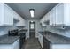 Contemporary kitchen featuring modern appliances, granite countertops, and white cabinetry at 136 Harrow Pl, Goose Creek, SC 29445