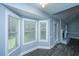 Bright living room featuring large windows, modern flooring, and a cozy fireplace, perfect for relaxing and entertaining at 136 Harrow Pl, Goose Creek, SC 29445