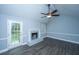 Inviting living room with a white fireplace, ceiling fan, stylish flooring, and natural light from a glass door at 136 Harrow Pl, Goose Creek, SC 29445