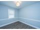 Bright room with wood-look flooring, trim, and a window offering natural light for a cozy and inviting space at 136 Harrow Pl, Goose Creek, SC 29445