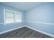 Well-lit room with new gray flooring, fresh paint, modern trim, and a large window provides a calming atmosphere at 136 Harrow Pl, Goose Creek, SC 29445