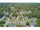Aerial shot of homes in a lush, green neighborhood, featuring mature trees and meticulously maintained lawns at 1503 Pondside Ct, Summerville, SC 29485